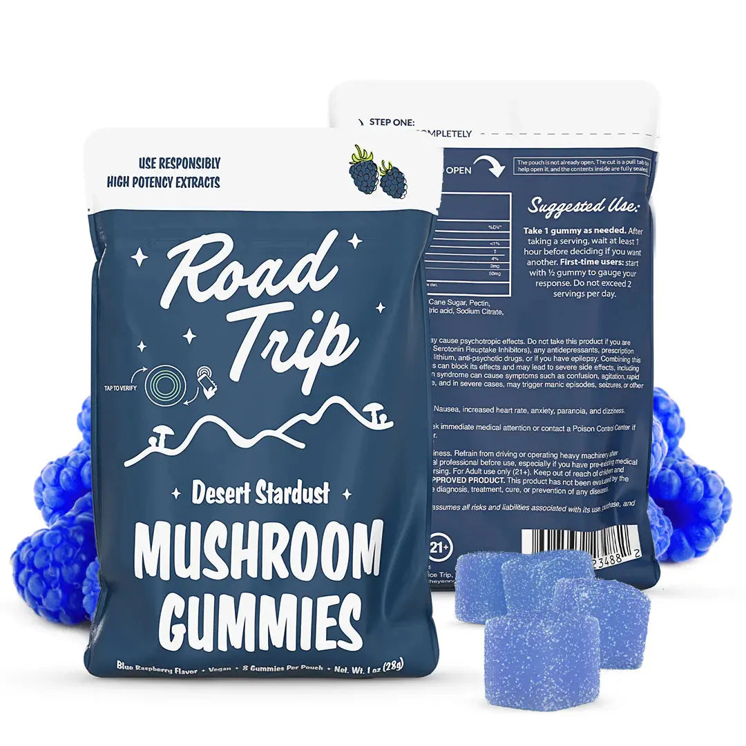 Road Trip Desert Stardust mushroom gummies Blue Raspberry flavor pouch with blue raspberry gummy candies, fresh raspberry and berry imagery, psychedelic inspired mushroom edible packaging, and premium fruit flavored gummy display